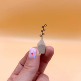 Small wooden vase with a plant on a blurred orange background