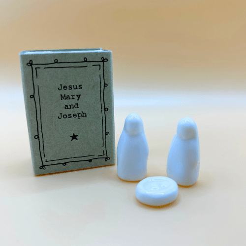Small box titled 'Jesus Mary and Joseph' with three white figurines on a beige background
