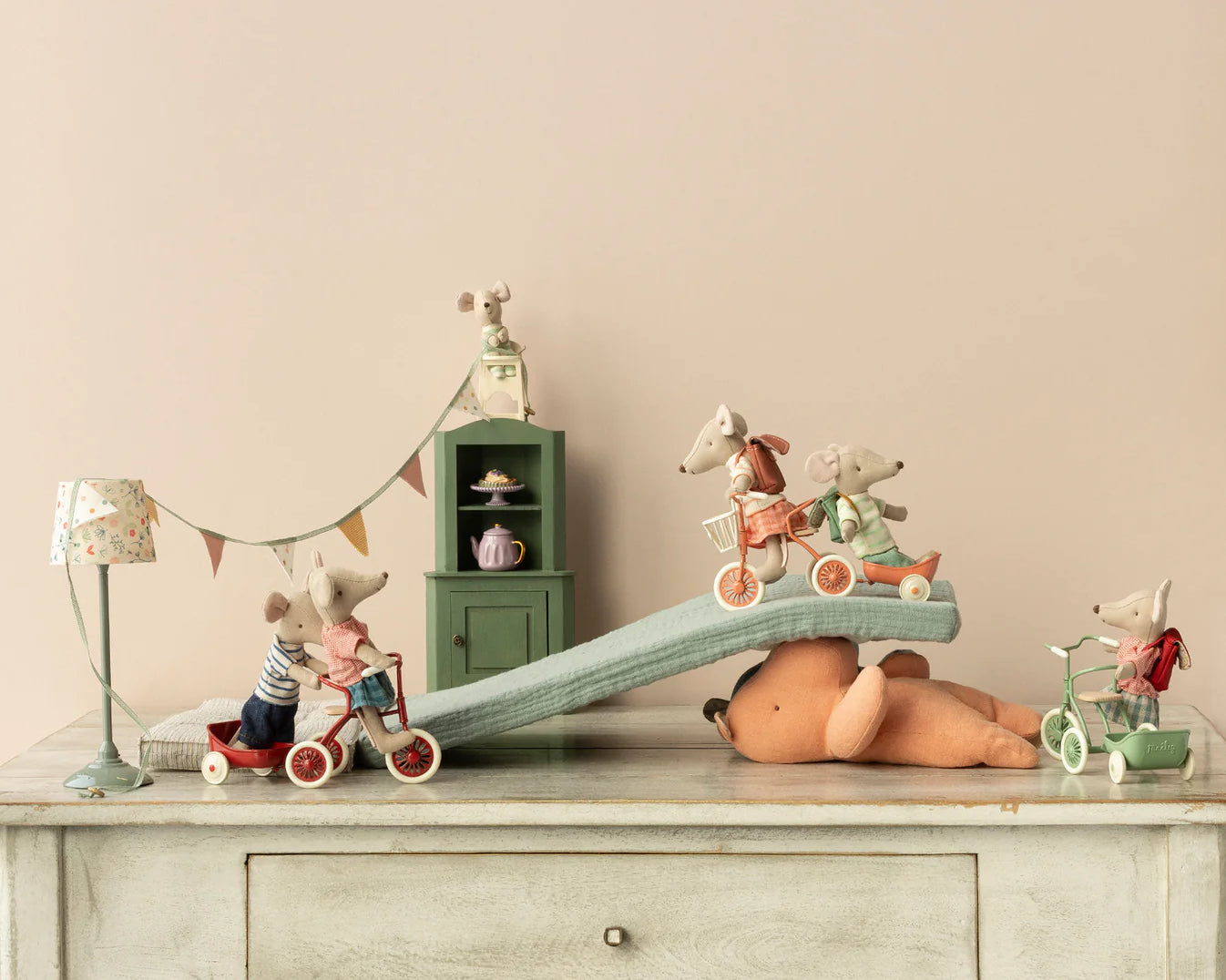 The maileg mice have made a ramp for their tricycles, the take it in turns to ride it in their different coloured bikes