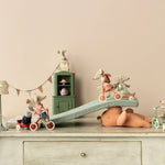 The maileg mice have made a ramp for their tricycles, the take it in turns to ride it in their different coloured bikes
